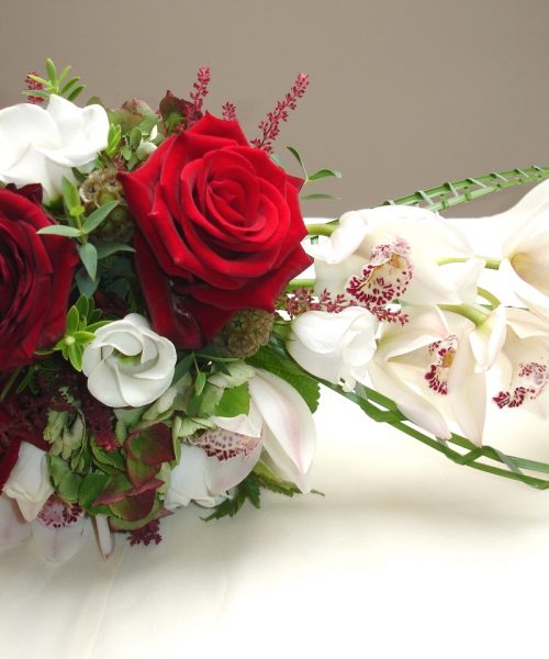 Modern-Trailing-Bouquet-Red-White-Green-Orchid-Rose -Larkspur-Floral-Design